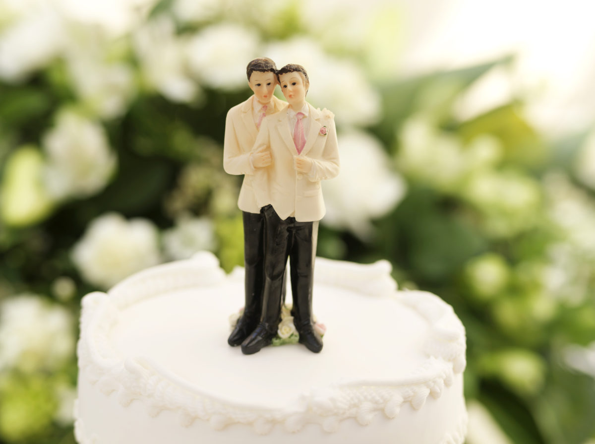 小雕像，描绘一个同性恋婚礼或民事伙伴关系，在婚礼蛋糕上，狭窄的焦点放在头部。