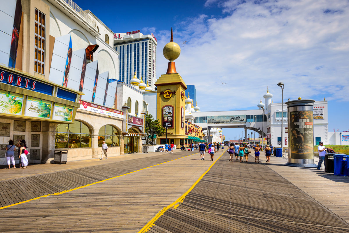 Atlantic City,New Jersey,USA - September 8,2012: Tourists walk on the boardwalk in Atlantic City.The city is popular for the numerous gambling resorts located there.