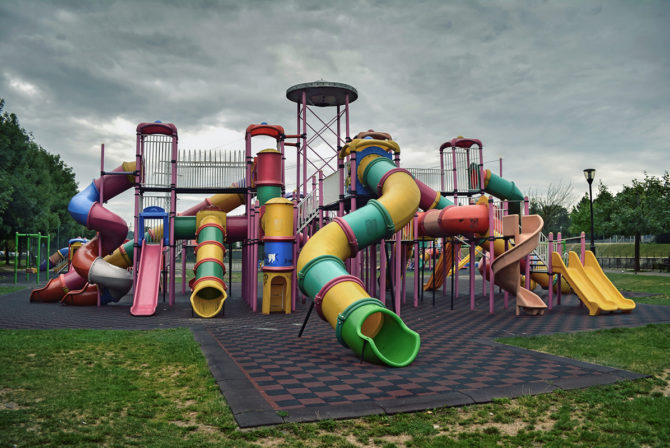 Slides On Playground Against Cloudy Sky At Park